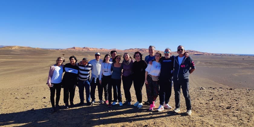 Small group of travelers visiting the Moroccan Sahara
