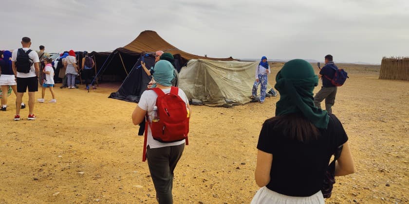 Travelers visiting local desert hosts respectfully